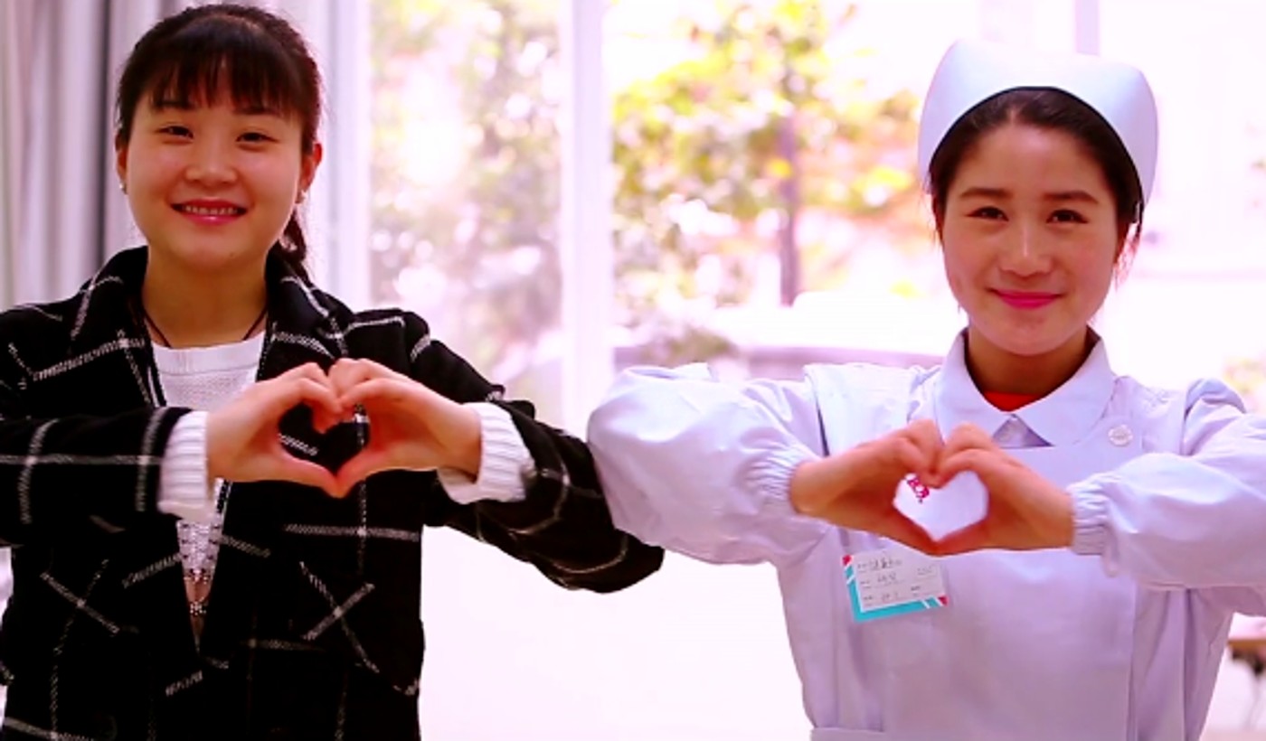 Two members of a local hospital care team standing together
