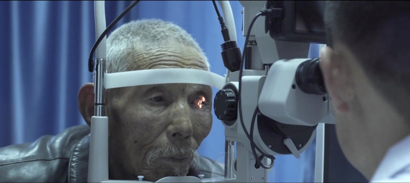 Older patient receiving a slit-lamp eye examination at the ophthalmology center