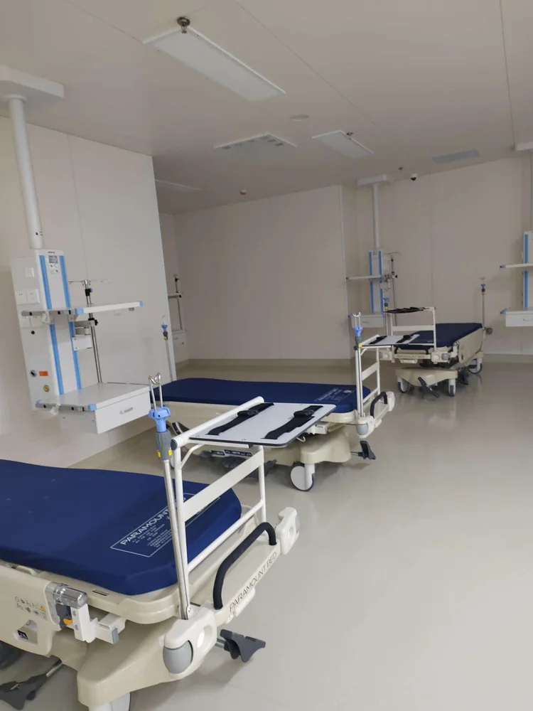 Patient beds and supporting equipment within a prepared care area.
