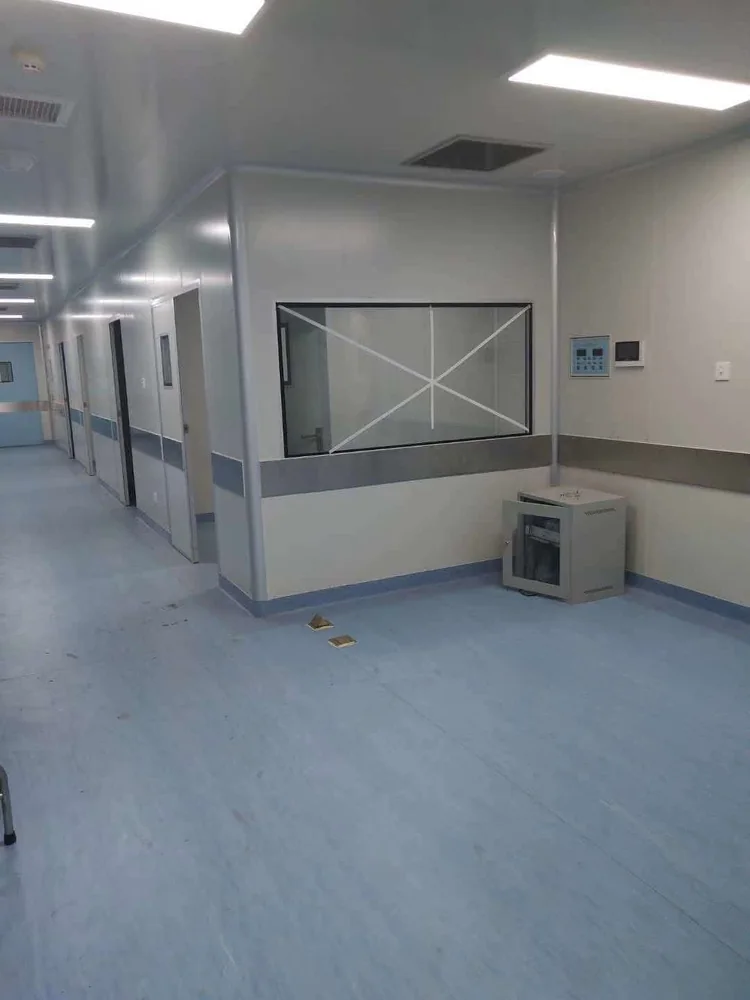 Protected glazing and local finishing work in a medical corridor.
